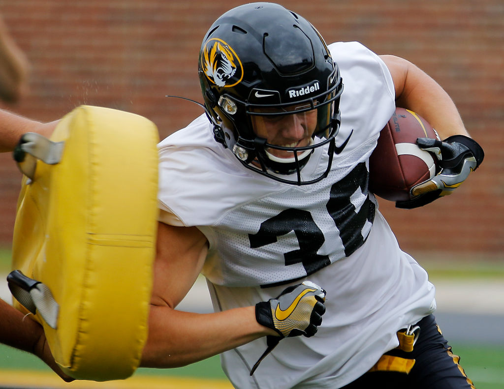 Daniel Ellinger elbows away a tackle dummy